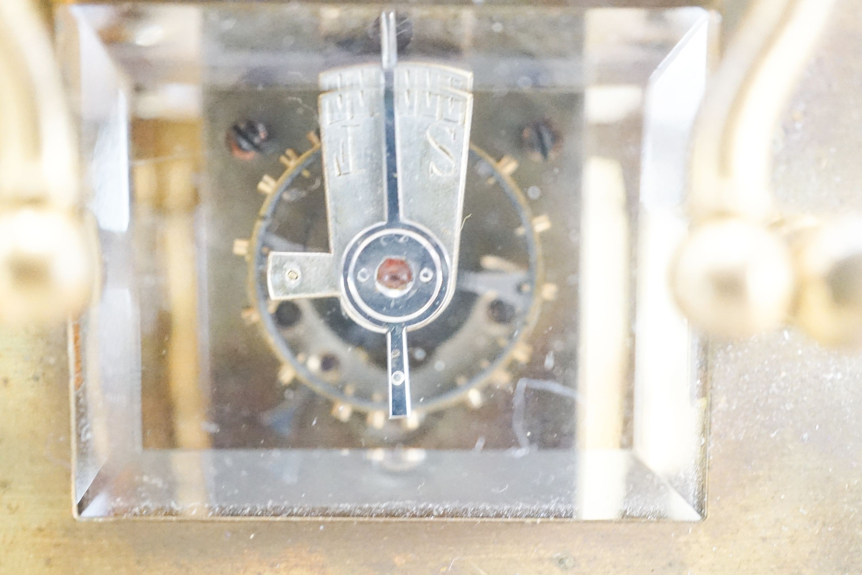 A Henri Jacot brass miniature carriage timepiece, 9.7 cm high with the handle up, cased